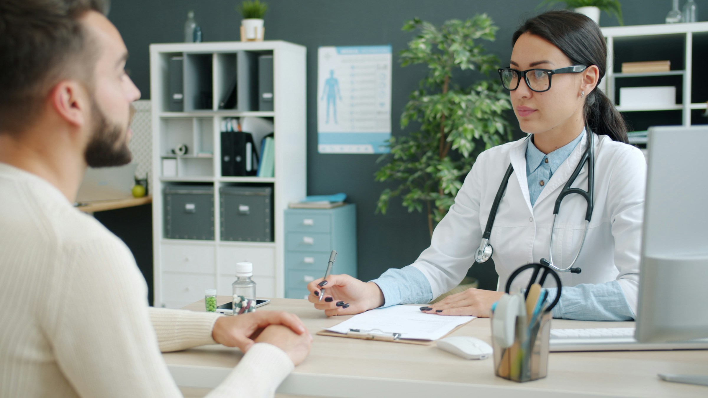 A man speaks to a doctor during the sperm donor process